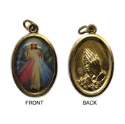 A religious medal with the Divine Mercy image on the front and a prayer hands motif on the back, displayed on a white background.